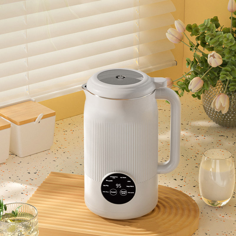 White electric kettle with digital display on a kitchen counter, surrounded by glasses of water and a vase with flowers.