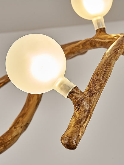 Chandelier with wooden branches and spherical light bulbs on a neutral background