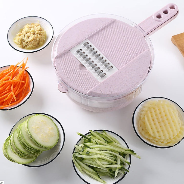 Pink mandoline slicer with sliced vegetables on a white surface