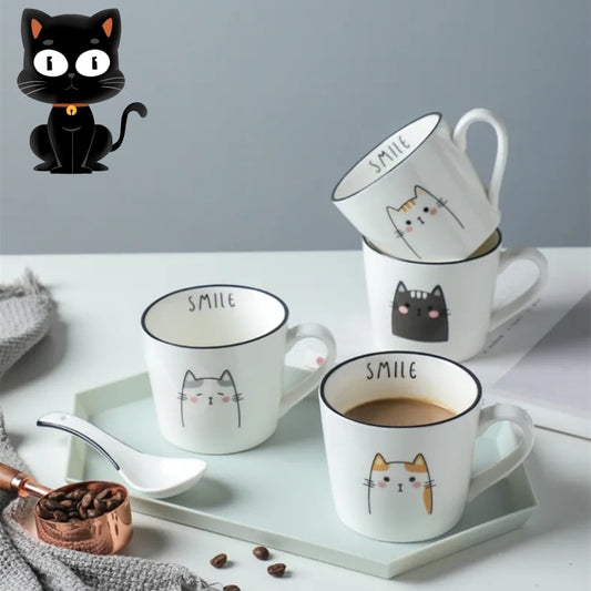 Set of white mugs with cat designs and 'SMILE' text on a light surface with coffee beans and a black cat figurine.