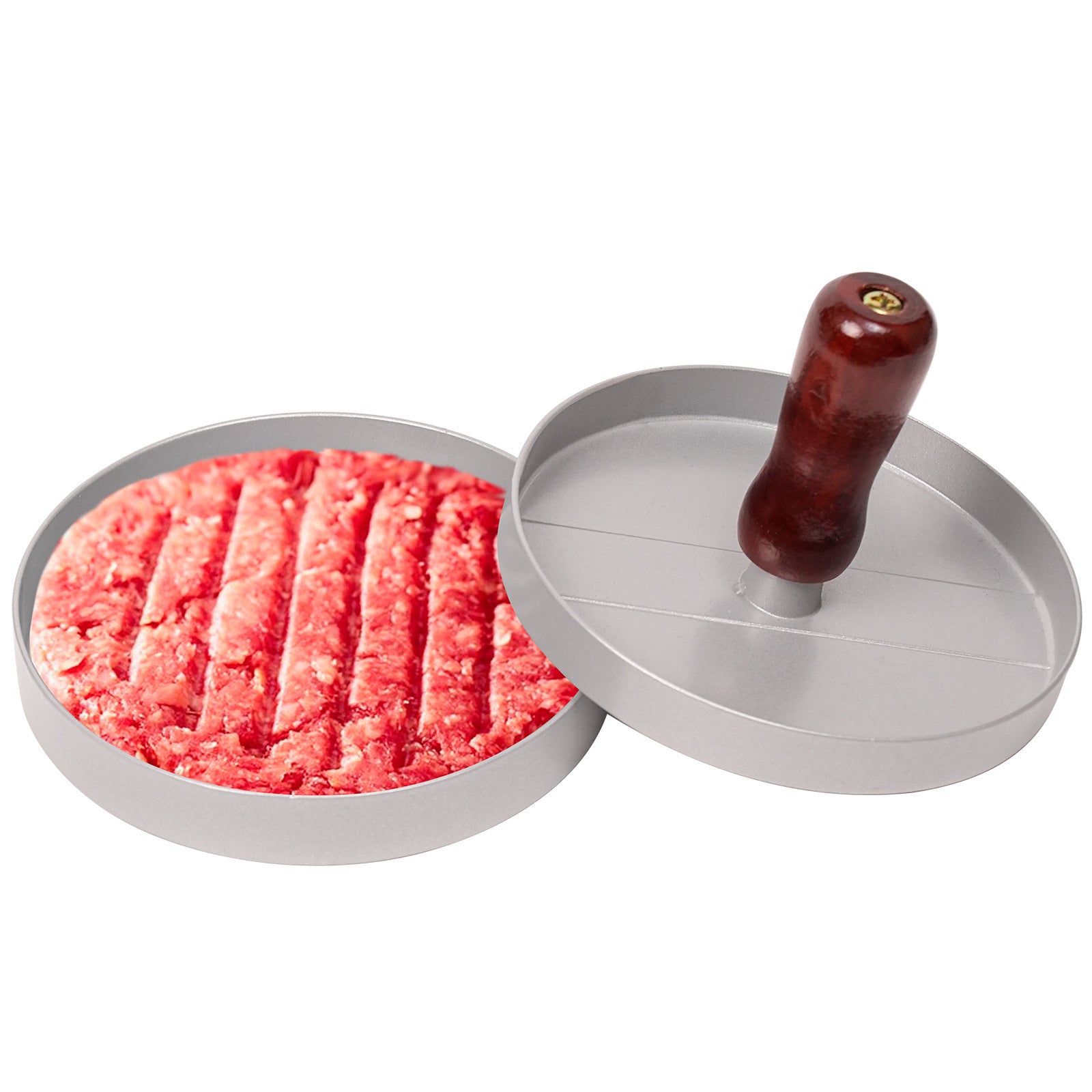 Hamburger meat being shaped by a metal patty press with a wooden handle on a white background.