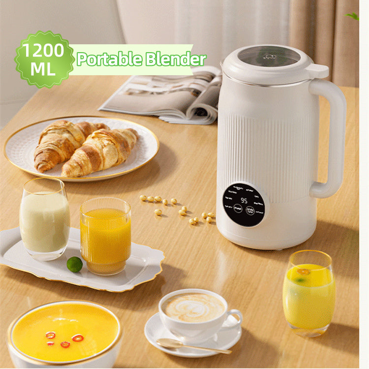 Portable blender on a table with breakfast items including croissants, juice, and coffee.
