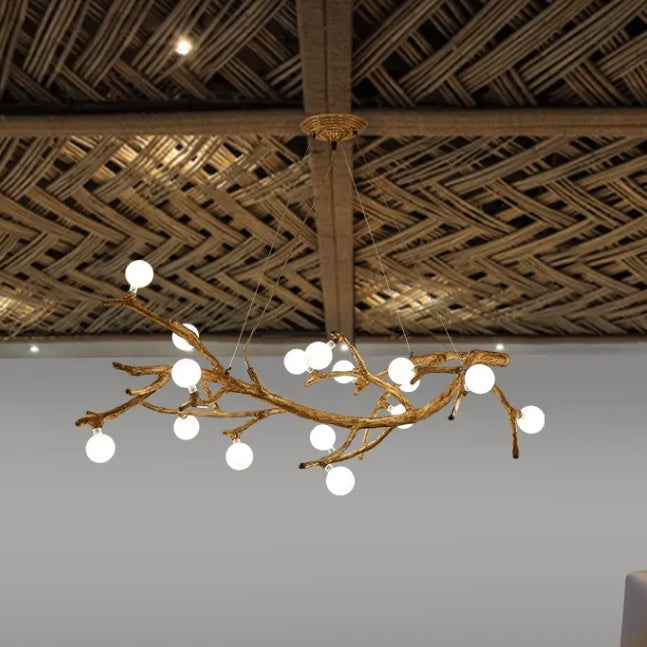 Chandelier with branch-like design hanging from a woven wooden ceiling.
