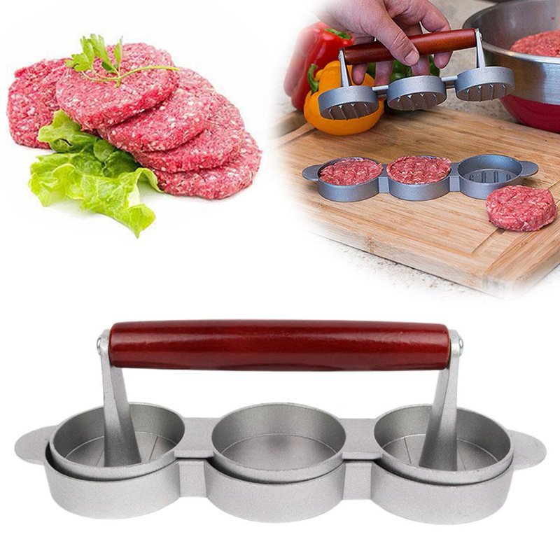 Hamburger press with raw meat patties and ingredients on a white background
