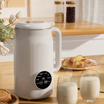 White electric kettle on a kitchen counter with glasses of milk and pastries.