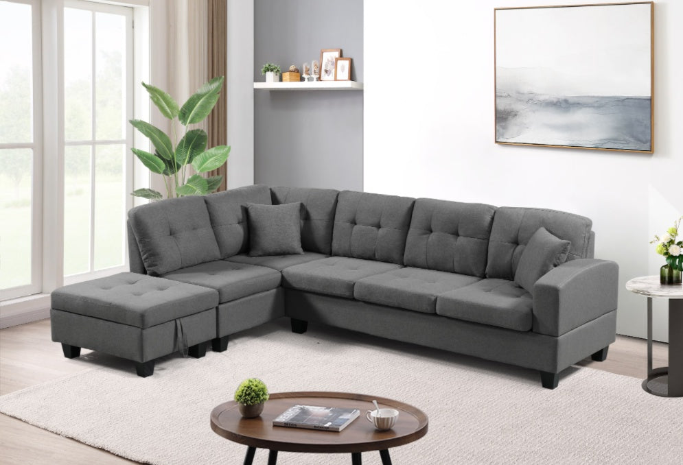 Gray sectional sofa in a living room setting with a coffee table and decor items.